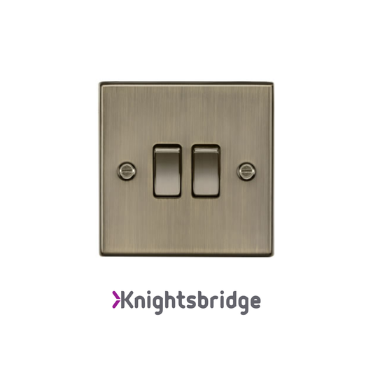 Brass light switch with 'Knightsbridge' branding on a white background